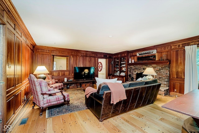 6280 N Chester Ave, Indianapolis, IN 46220 - living area with wood walls, light wood-type flooring, a fireplace, and ornamental molding