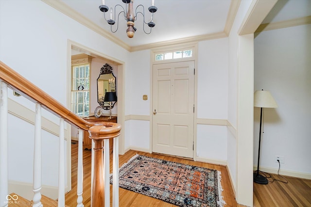 6280 N Chester Ave, Indianapolis, IN 46220 - foyer featuring a chandelier, light wood-style floors, and ornamental molding