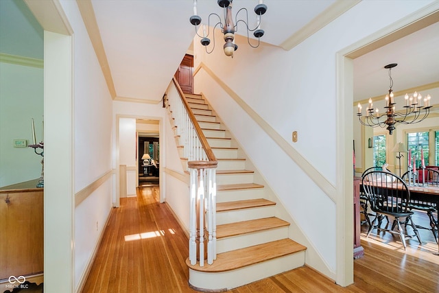 6280 N Chester Ave, Indianapolis, IN 46220 - staircase featuring a chandelier, ornamental molding, and wood finished floors