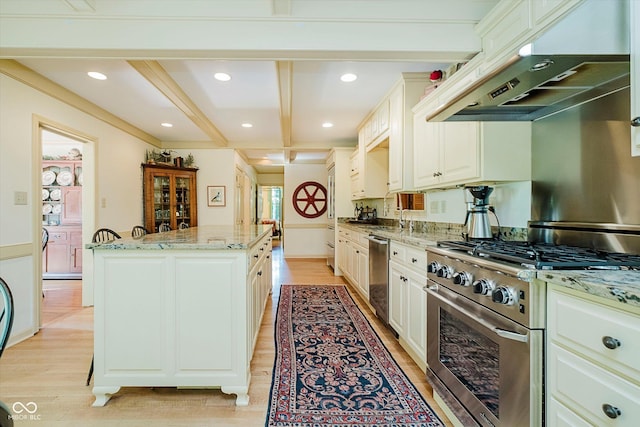 6280 N Chester Ave, Indianapolis, IN 46220 - kitchen featuring stainless steel appliances, a center island, light wood-type flooring, under cabinet range hood, and beamed ceiling