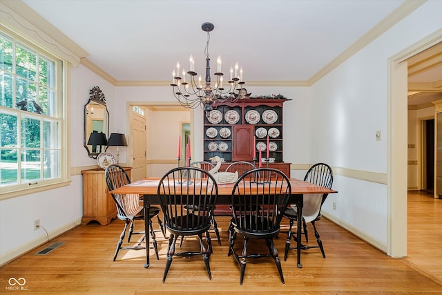 6280 N Chester Ave, Indianapolis, IN 46220 - dining space featuring a chandelier, plenty of natural light, light wood finished floors, and crown molding