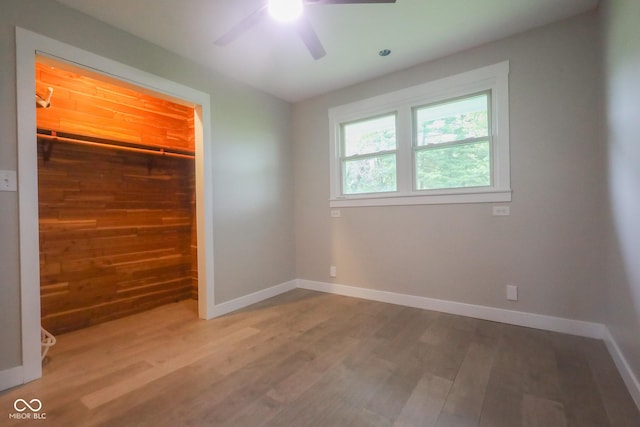 7300 N Banta Rd, Bargersville, IN 46106 - unfurnished bedroom featuring wood finished floors, a spacious closet, a closet, and ceiling fan