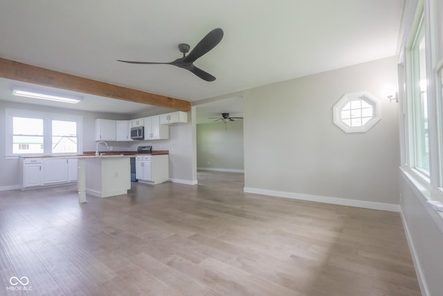 7300 N Banta Rd, Bargersville, IN 46106 - unfurnished living room with ceiling fan, light wood finished floors, and beamed ceiling