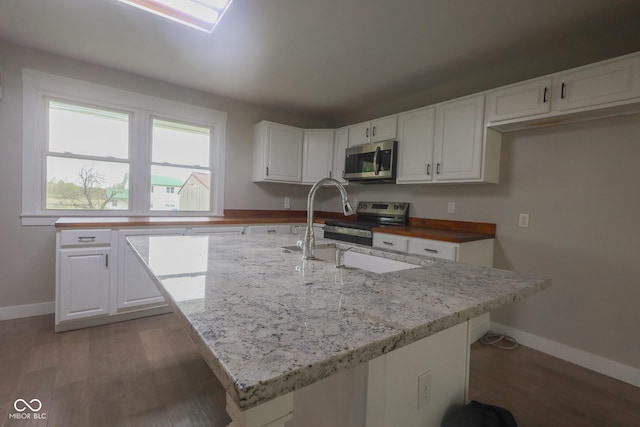 7300 N Banta Rd, Bargersville, IN 46106 - kitchen with stainless steel appliances, white cabinetry, light wood finished floors, and light stone countertops