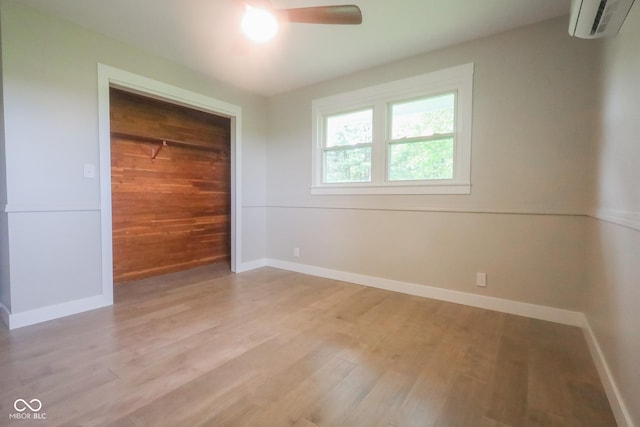 7300 N Banta Rd, Bargersville, IN 46106 - unfurnished bedroom with light wood-type flooring, a wall unit AC, and ceiling fan