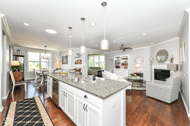 13427 Merryvale St, Fishers, IN 46037 - kitchen featuring ornamental molding, a center island with sink, dark wood-style floors, a fireplace, and open floor plan