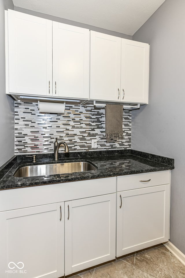 13427 Merryvale St, Fishers, IN 46037 - kitchen featuring decorative backsplash, white cabinets, and dark stone counters