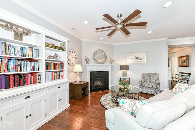 13427 Merryvale St, Fishers, IN 46037 - living area featuring a ceiling fan, recessed lighting, a glass covered fireplace, ornamental molding, and dark wood-style flooring