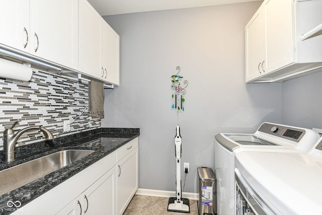13427 Merryvale St, Fishers, IN 46037 - laundry area featuring washer and clothes dryer, cabinet space, and light tile patterned floors