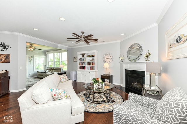 13427 Merryvale St, Fishers, IN 46037 - living room with a ceiling fan, wood finished floors, recessed lighting, ornamental molding, and a glass covered fireplace