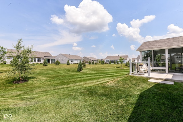 13427 Merryvale St, Fishers, IN 46037 - view of grassy yard with a residential view, a patio area, and a sunroom