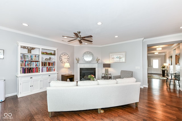 13427 Merryvale St, Fishers, IN 46037 - living area with ceiling fan, a glass covered fireplace, recessed lighting, crown molding, and dark wood-style flooring