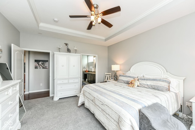 13427 Merryvale St, Fishers, IN 46037 - bedroom with a tray ceiling, ornamental molding, light carpet, a ceiling fan, and connected bathroom