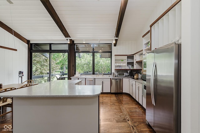 1616 W 116th St, Carmel, IN 46032 - kitchen with stainless steel appliances, open shelves, dark wood finished floors, beam ceiling, and a center island