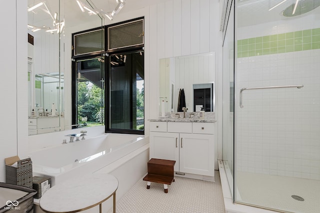 1616 W 116th St, Carmel, IN 46032 - bathroom with a stall shower, vanity, a garden tub, and a chandelier