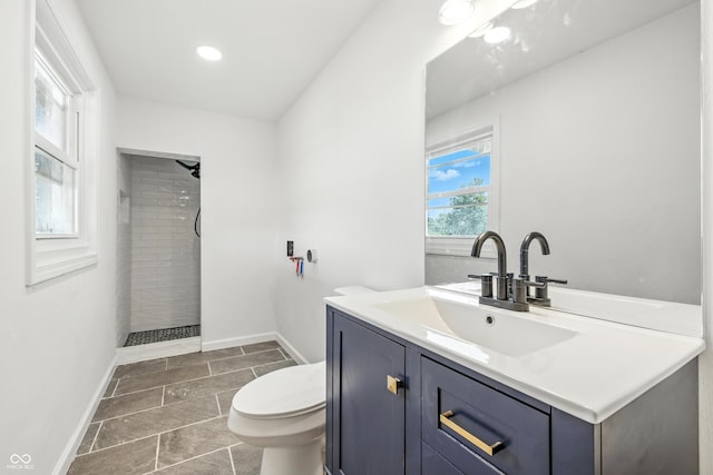 1011 Robin Dr, Anderson, IN 46013 - bathroom featuring tiled shower, vanity, and recessed lighting