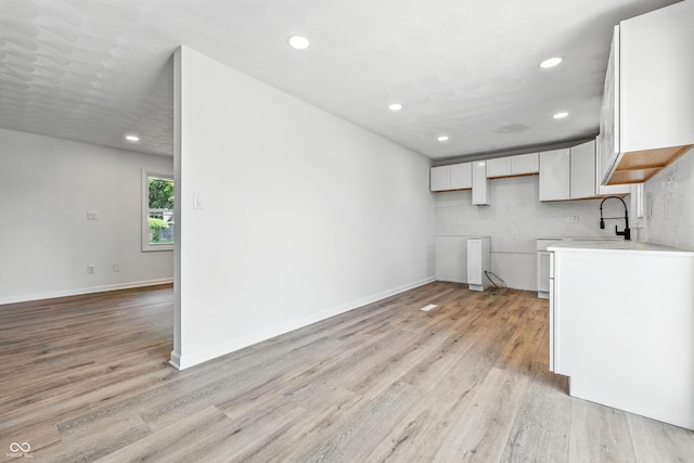 1011 Robin Dr, Anderson, IN 46013 - unfurnished living room featuring light wood-style floors and recessed lighting