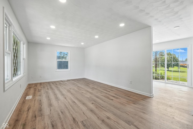 1011 Robin Dr, Anderson, IN 46013 - empty room with light wood finished floors and recessed lighting