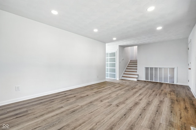 1011 Robin Dr, Anderson, IN 46013 - unfurnished room with stairs, recessed lighting, and wood finished floors