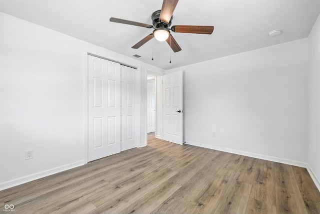 1011 Robin Dr, Anderson, IN 46013 - unfurnished bedroom with a closet, wood finished floors, and a ceiling fan
