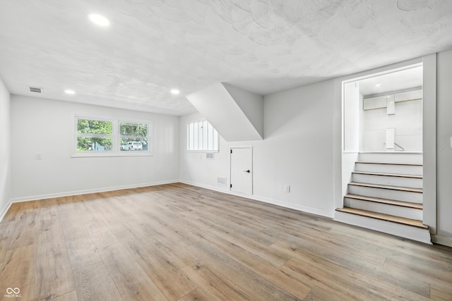1011 Robin Dr, Anderson, IN 46013 - additional living space featuring wood finished floors, stairway, and recessed lighting