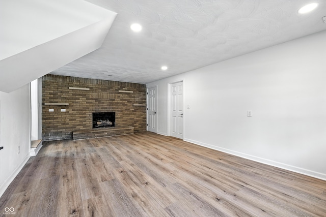 1011 Robin Dr, Anderson, IN 46013 - unfurnished living room featuring recessed lighting, a fireplace, and wood finished floors