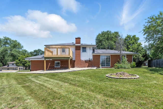 1011 Robin Dr, Anderson, IN 46013 - rear view of house featuring a chimney, brick siding, and a deck