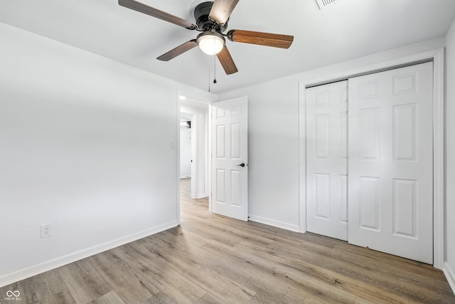 1011 Robin Dr, Anderson, IN 46013 - unfurnished bedroom with light wood finished floors, a closet, and ceiling fan