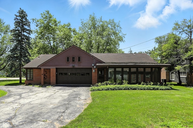1600 W Walnut St, Kokomo, IN 46901 - view of front of home with asphalt driveway, a garage, a front lawn, brick siding, and roof with shingles