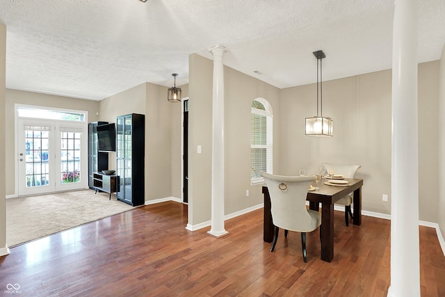 6298 Briargate Dr, Zionsville, IN 46077 - dining space featuring decorative columns, wood finished floors, and a textured ceiling