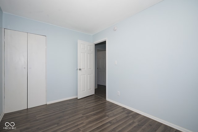 2606 Shakespeare Dr, Southport, IN 46227 - unfurnished bedroom featuring dark wood-style flooring and a closet
