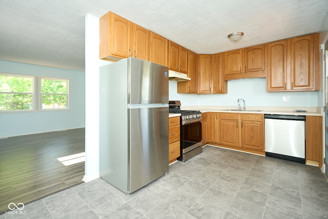 2606 Shakespeare Dr, Southport, IN 46227 - kitchen featuring appliances with stainless steel finishes, under cabinet range hood, and light countertops