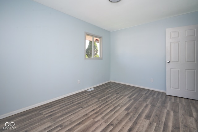 2606 Shakespeare Dr, Southport, IN 46227 - unfurnished room featuring dark wood-style flooring and baseboards