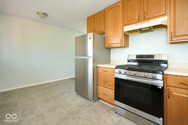 2606 Shakespeare Dr, Southport, IN 46227 - kitchen featuring appliances with stainless steel finishes, under cabinet range hood, and light countertops