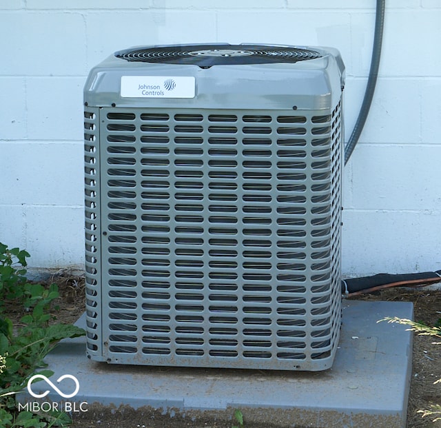 2606 Shakespeare Dr, Southport, IN 46227 - exterior view of concrete block siding and a central AC unit