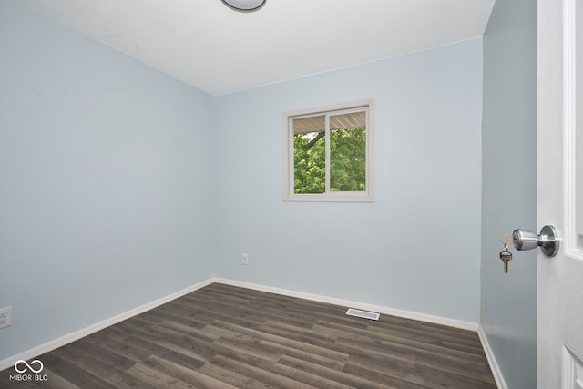 2606 Shakespeare Dr, Southport, IN 46227 - spare room featuring dark wood-style flooring and baseboards