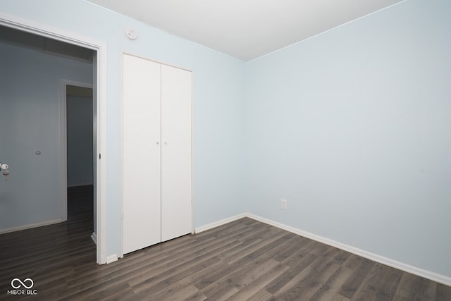 2606 Shakespeare Dr, Southport, IN 46227 - unfurnished bedroom featuring dark wood finished floors and a closet