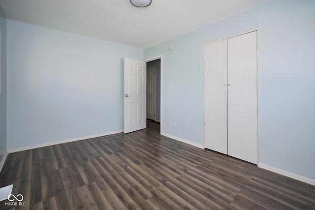 2606 Shakespeare Dr, Southport, IN 46227 - unfurnished bedroom with dark wood-style flooring and a closet