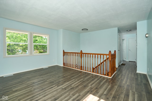 2606 Shakespeare Dr, Southport, IN 46227 - spare room with wood finished floors and a textured ceiling