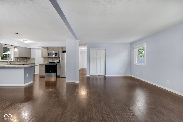 1231 N Graham Ave, Indianapolis, IN 46219 - unfurnished living room with baseboards and dark wood-style flooring