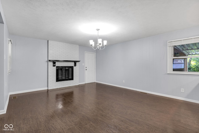 1231 N Graham Ave, Indianapolis, IN 46219 - unfurnished living room with a chandelier, dark wood-style flooring, and a fireplace