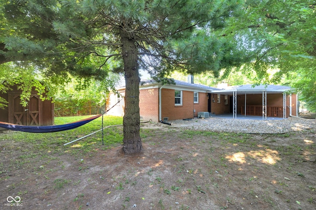 1231 N Graham Ave, Indianapolis, IN 46219 - rear view of house featuring brick siding, a storage shed, and a patio area