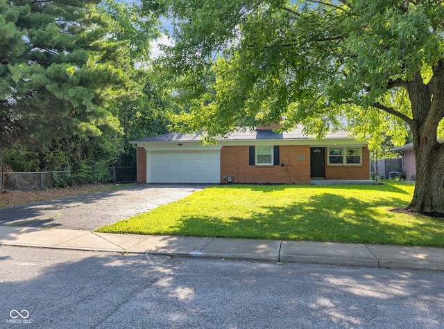 1231 N Graham Ave, Indianapolis, IN 46219 - view of front of property with a garage, asphalt driveway, and brick siding