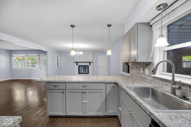 1231 N Graham Ave, Indianapolis, IN 46219 - kitchen with gray cabinetry, a peninsula, open floor plan, and light countertops