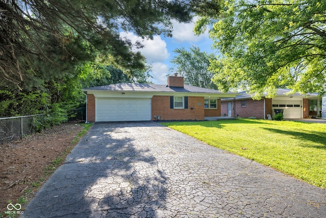 1231 N Graham Ave, Indianapolis, IN 46219 - single story home with a garage, brick siding, and asphalt driveway