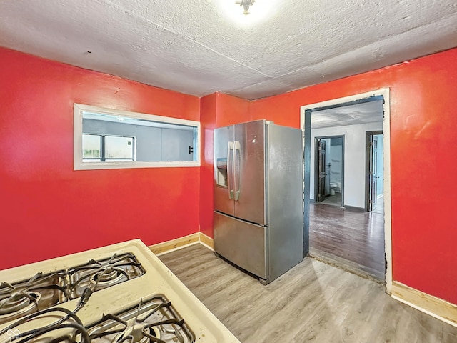 356 S 7th St, Frankfort, IN 46041 - kitchen featuring stainless steel fridge with ice dispenser, wood finished floors, and a textured ceiling