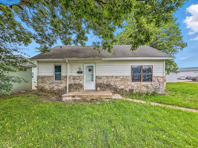 356 S 7th St, Frankfort, IN 46041 - view of front facade with stone siding, a front yard, and roof with shingles