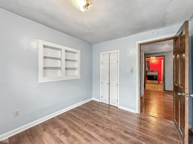 356 S 7th St, Frankfort, IN 46041 - unfurnished bedroom with dark wood finished floors, a textured ceiling, and a closet