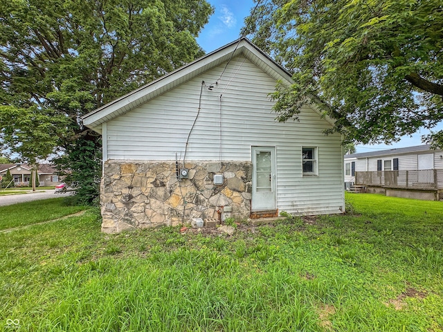 356 S 7th St, Frankfort, IN 46041 - view of side of property featuring stone siding and a lawn