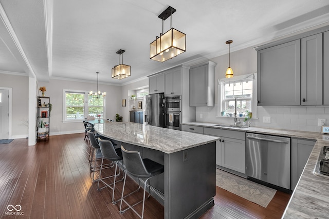 3101 N Washington Blvd, Indianapolis, IN 46205 - kitchen with appliances with stainless steel finishes, gray cabinetry, dark wood finished floors, and ornamental molding